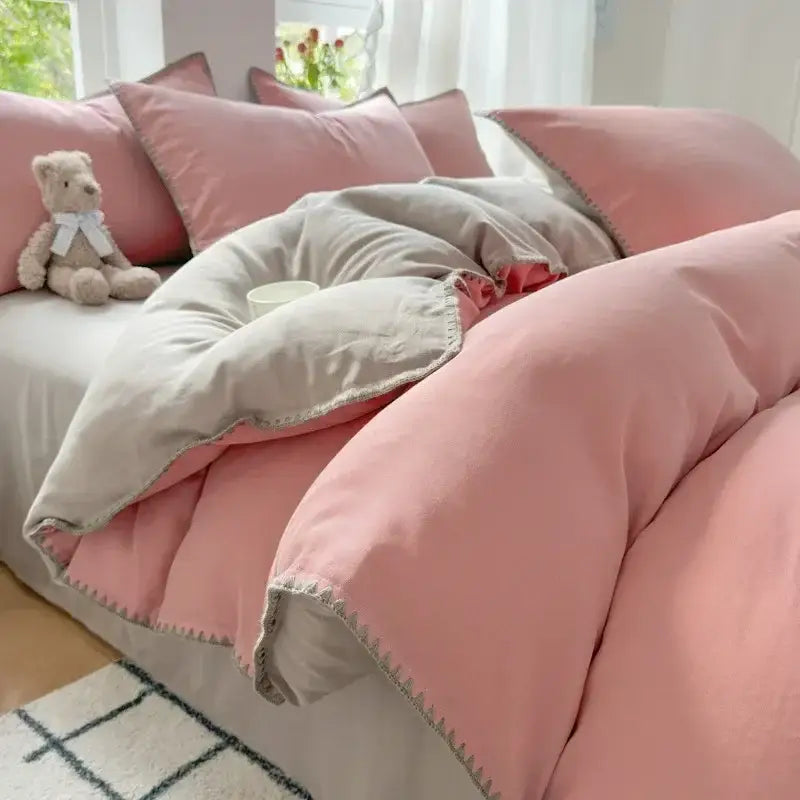 Blush pink and gray cotton bedding set with quilted zigzag stitch and soft textured fabric finish