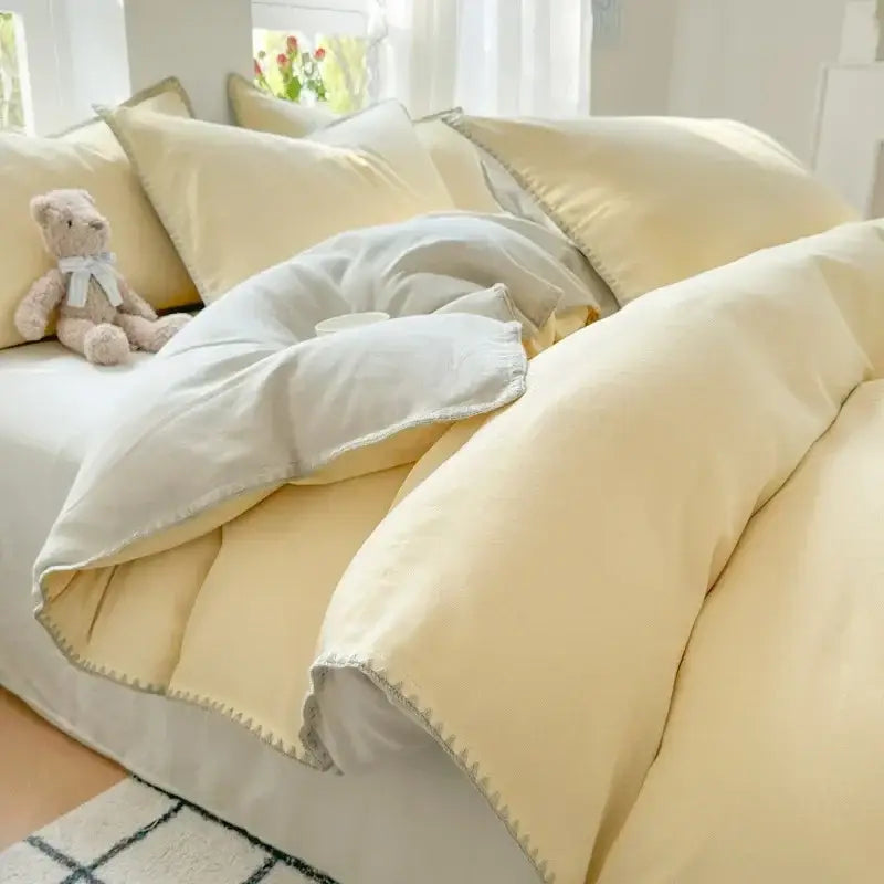 Soft pale yellow quilted cotton bedding set with subtle gray stitching, part of blush pink and gray cotton bedding collection