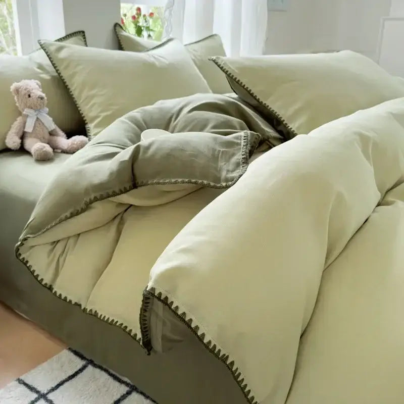 Soft sage green cotton bedding set with subtle zigzag stitch trim featured in blush pink and gray cotton bedding collection