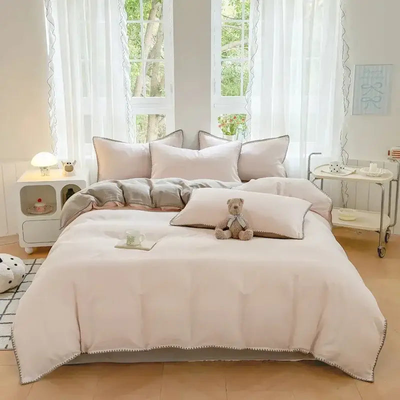 Blush pink and gray cotton bedding set featuring a soft blush pink duvet with delicate scalloped edge detailing