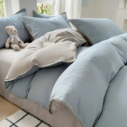 Soft pastel blue cotton bedding set with subtle texture and delicate white trim for bedroom use