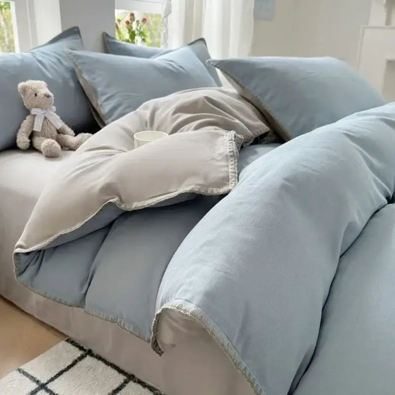 Soft pastel blue cotton bedding set with subtle texture and delicate white trim for bedroom use