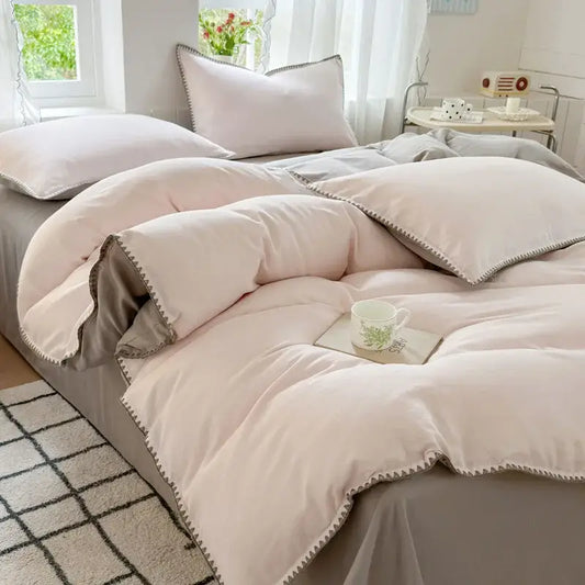 Blush pink and gray cotton edge embroidery bedding set with soft quilted duvet and cozy plush texture by decorbites