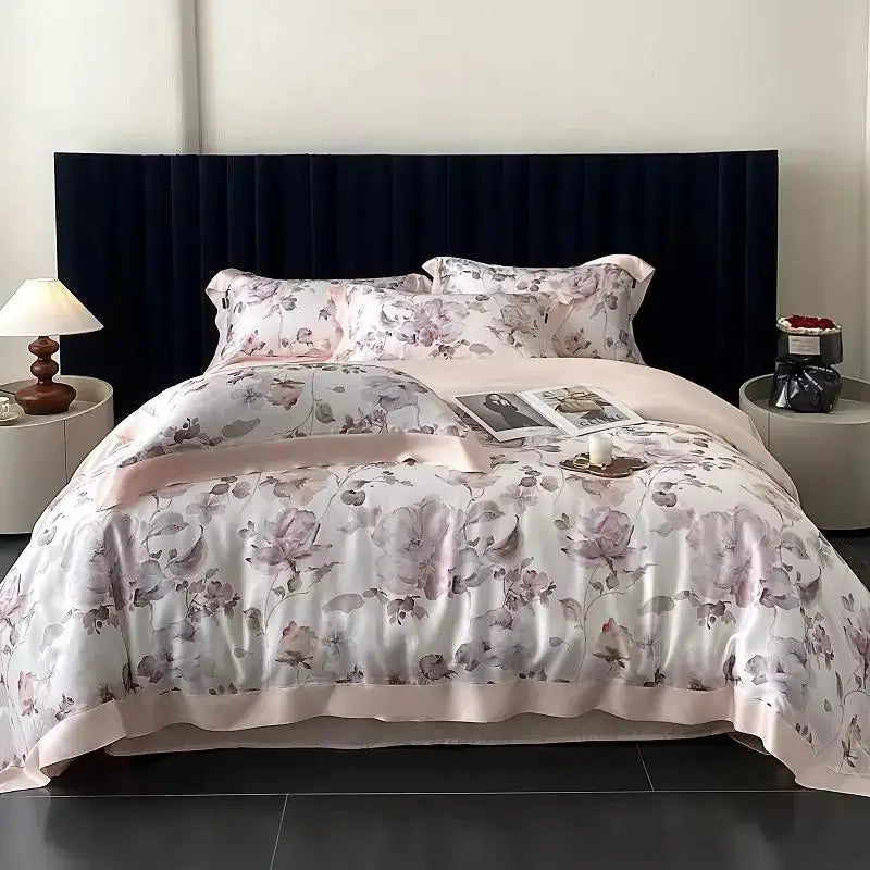 A blush rose eucalyptus fiber flowers bedding set in soft lavender satin with floral pattern and elegant ruffled edges