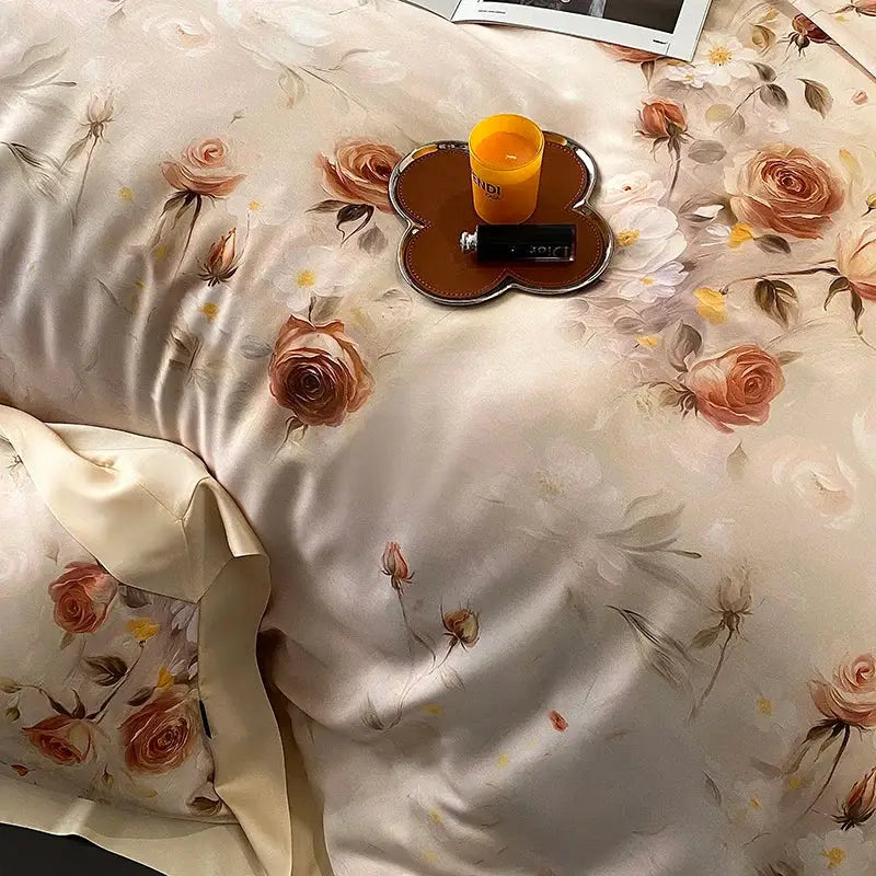 Cream-colored satin bedding set with blush rose eucalyptus fiber flowers in soft peach and muted brown tones