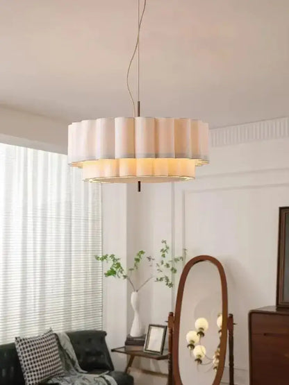 A modern two-tiered bohemia fabric chandelier pendant with cream pleated shade and warm illumination for living room decorbites