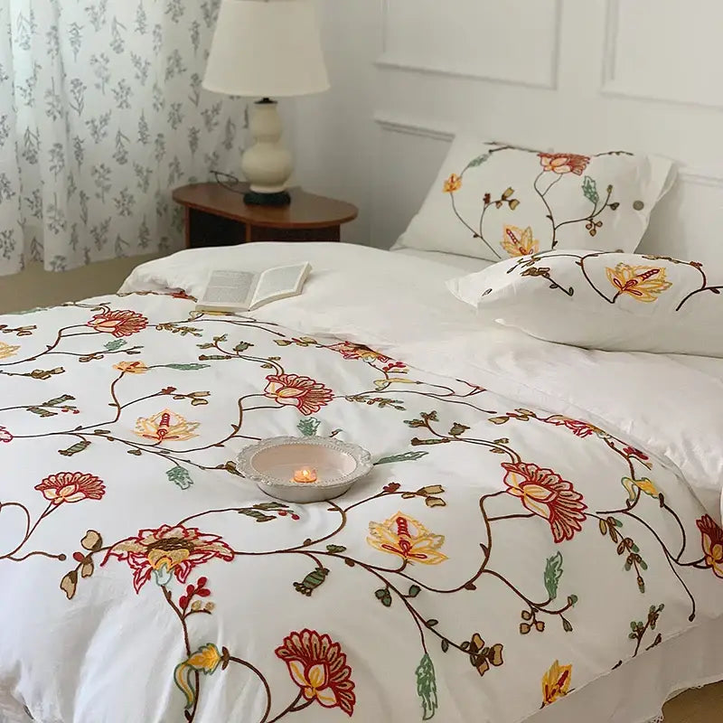 White cotton duvet cover with intricate red yellow and green floral embroidery vine design from decorbites cotton bohemia bedding set