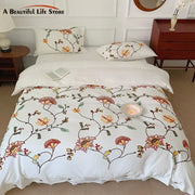 White cotton duvet cover bedding set with intricate bohemia floral embroidery in red orange yellow and green by decorbites