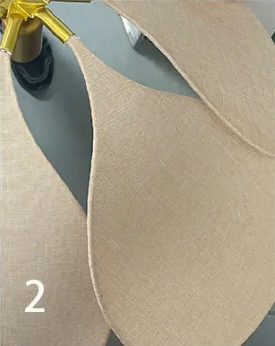 Beige linen-like fabric inserts with subtle woven texture and gold-toned hardware on decorbites bohemia linen e27 pendant light