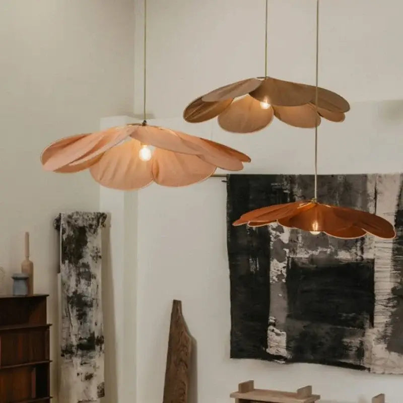 Three copper-toned flower-shaped pendant lights with layered petals in decorbites bohemia linen e27 cream pendant light