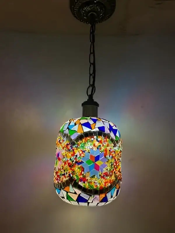 A vibrant cylindrical bohemia turkish mosaic pendant light with colorful glass tiles in geometric patterns for bedroom use