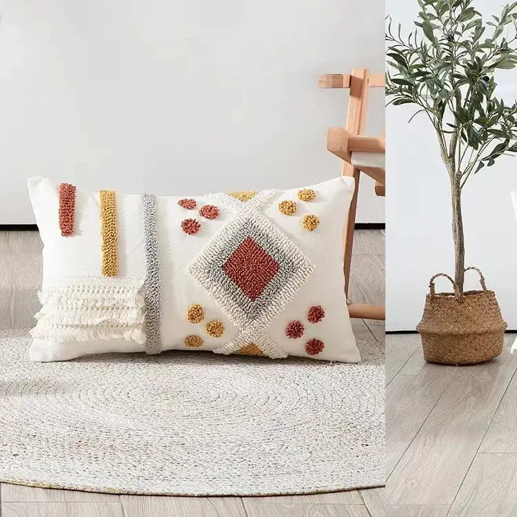 White rectangular cushion cover with terracotta and mustard yellow bohemian tufted tassel patterns for living room decor