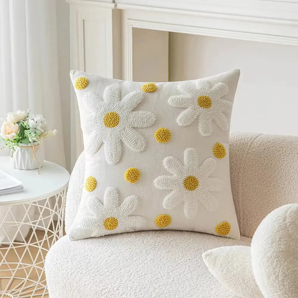 White bohemian tufted cushion cover with embroidered daisies yellow centers and pom-pom accents for decorbites bohemian tufted tassel decor