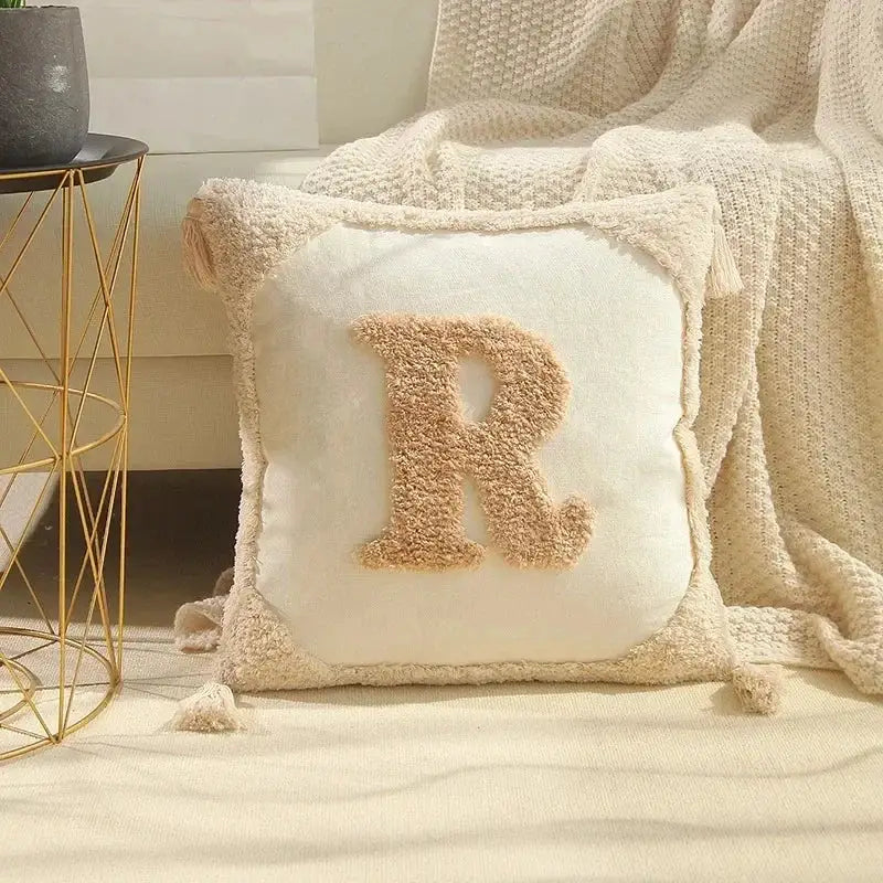 Cream-colored plush cushion cover with textured fuzzy r appliqué and bohemian tufted tassel trim decorbites bohemian tufted