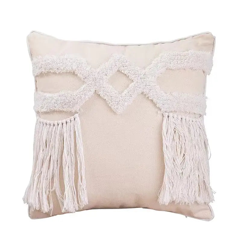 Beige cushion cover with white macrame-style fringe and bohemian tufted tassel accents for living room decorbites design