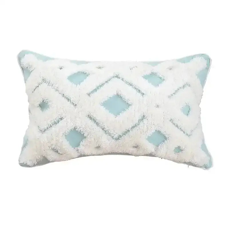A rectangular bohemian tufted cushion cover with soft white fringe over light blue fabric for decorbites bohemian tufted tassel decor