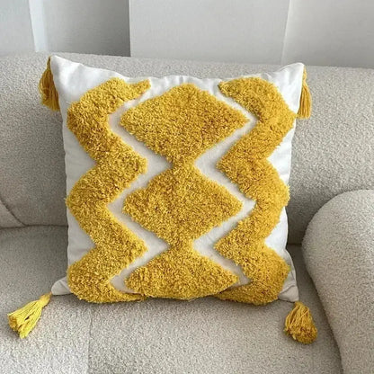 A vibrant yellow and white bohemian tufted cushion cover with geometric pattern and tassels for living room decorbites decor