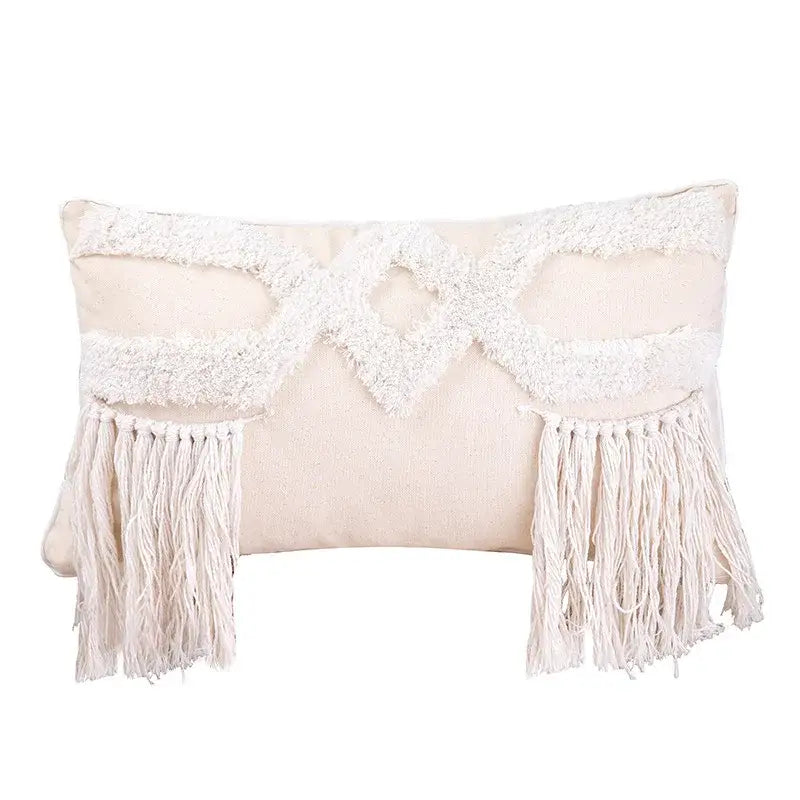 Cream-colored rectangular cushion cover with textured white woven pattern and bohemian tufted tassel fringe sides