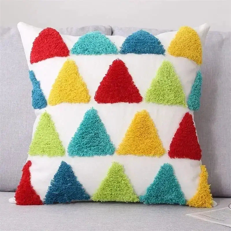 A colorful plush cushion cover with vibrant triangular patterns in red yellow green and blue for decorbites bohemian tufted decor
