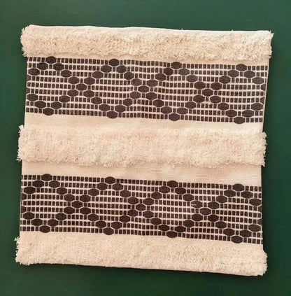 Beige towel with frayed edges and dark brown geometric bands for decorbites bohemian tufted cushion cover pillow
