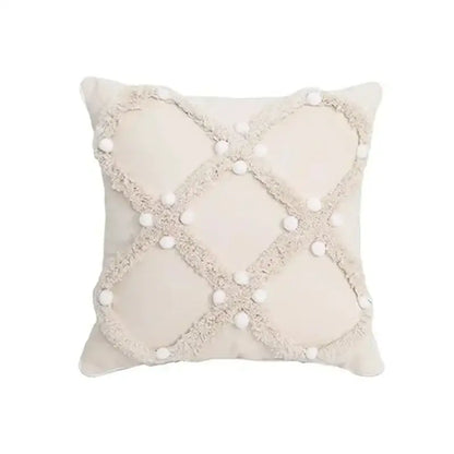 Cream-colored bohemian tufted cushion cover with textured frayed crosshatch and white pom-poms for living room decorbites decor