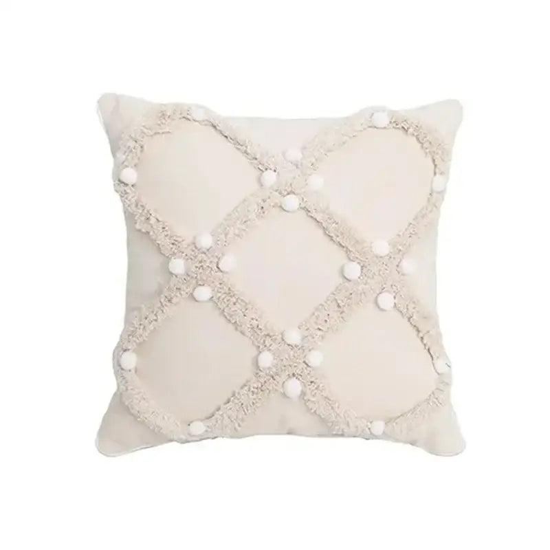 Cream-colored bohemian tufted cushion cover with textured frayed crosshatch and white pom-poms for living room decorbites decor