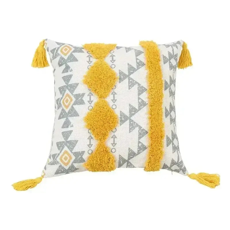 Bohemian beige and brown tufted cushion cover with gray geometric patterns and mustard-yellow bohemian tufted tassel edges