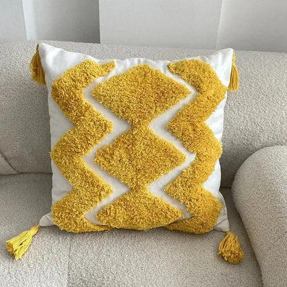 A cozy white square cushion cover with bold yellow geometric bohemian tufted tassel decorbites bohemian tufted design