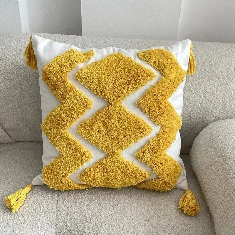A cozy white square cushion cover with bold yellow geometric bohemian tufted tassel decorbites bohemian tufted design