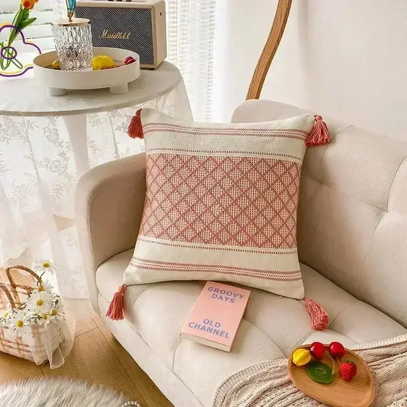Bohemian beige and brown tufted cushion cover with cozy cream and dusty rose woven fabric and bohemian tufted tassel accents