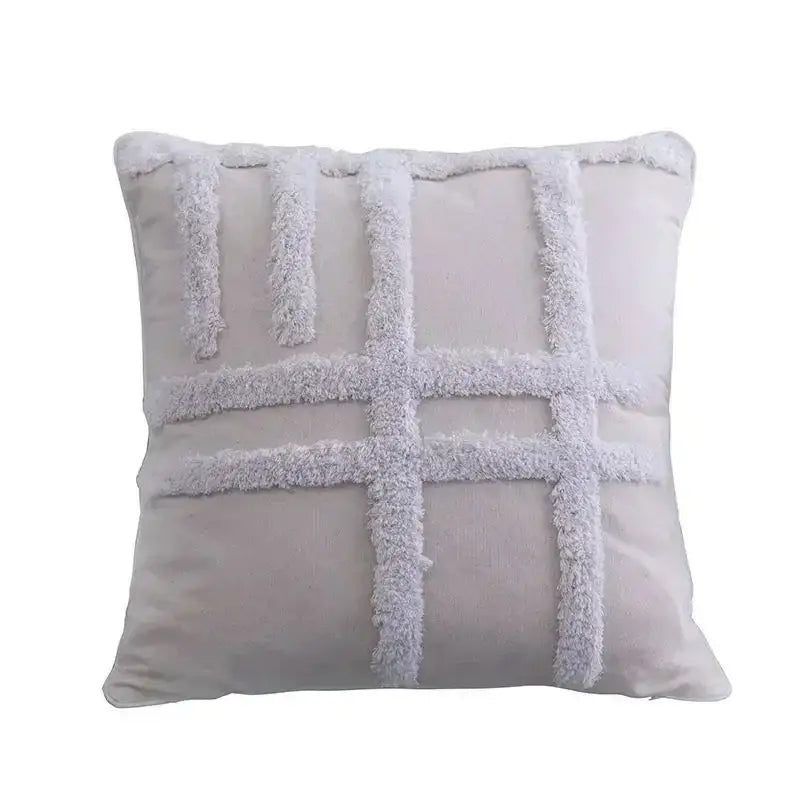 A soft light gray cushion cover with a plush textured grid pattern from decorbites bohemian tufted tassel collection