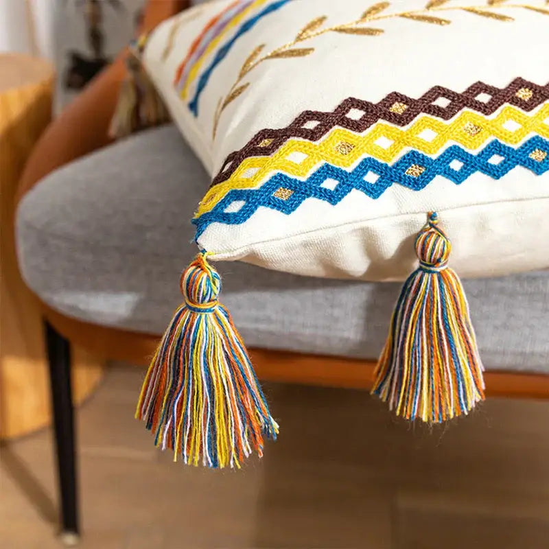 Cream-colored decorbites bohemian cotton cushion cover with vibrant embroidery and colorful tassels for living room decor
