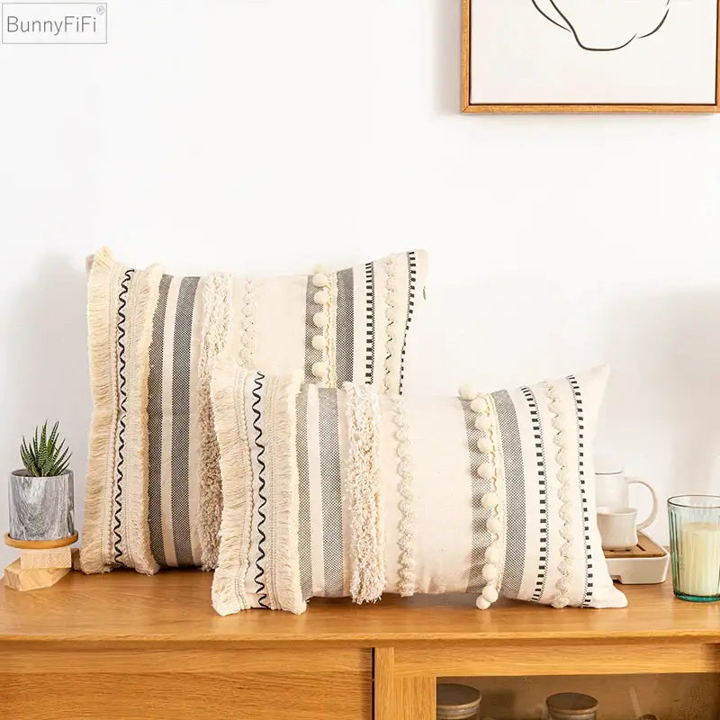 Beige and gray striped throw pillows with textured fringe pom-poms and woven details bohemian beige cushion cover decorbites