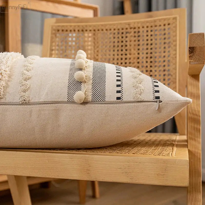 Beige linen bohemian cushion cover with black white geometric stripes cream pom-poms and frayed lace trim for home decor