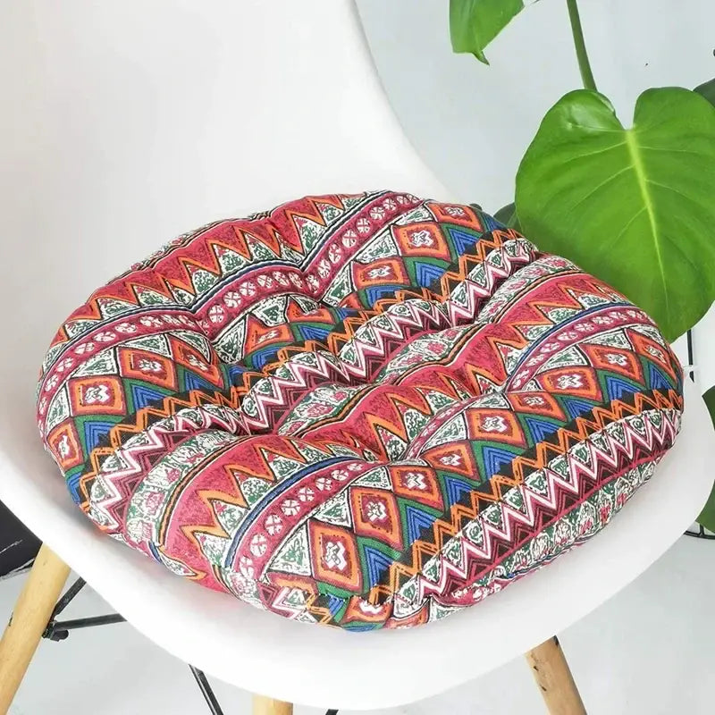 A vibrant bohemian blue green and red geometric meditation cushion pouf with cushioned fabric surface