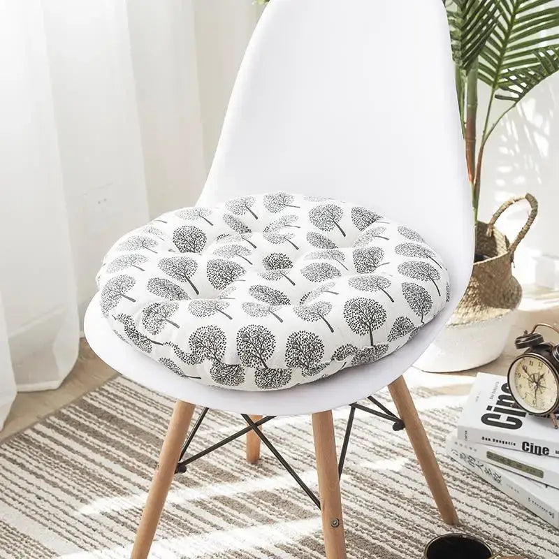 White circular cushion pouf with black tree pattern upholstered in soft fabric for meditation cushion use
