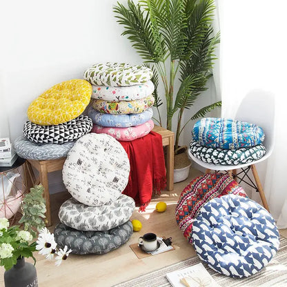 A collection of round cushioned meditation cushion poufs in vibrant geometric, floral, and abstract patterns for living rooms