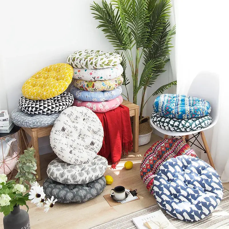 A collection of round cushioned meditation cushion poufs in vibrant geometric, floral, and abstract patterns for living rooms
