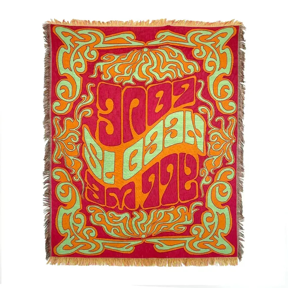 Vibrant red woven throw blanket with psychedelic lettering and swirling patterns in bohemian classic design thread style