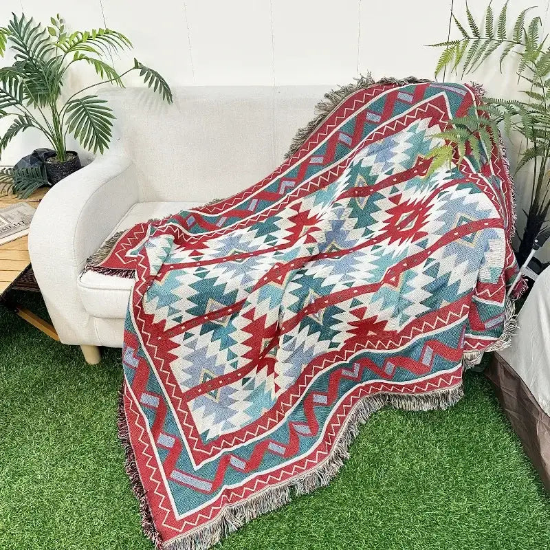 A cozy decorbites bohemian classic throw blanket with vibrant red teal white geometric pattern and fringed edges