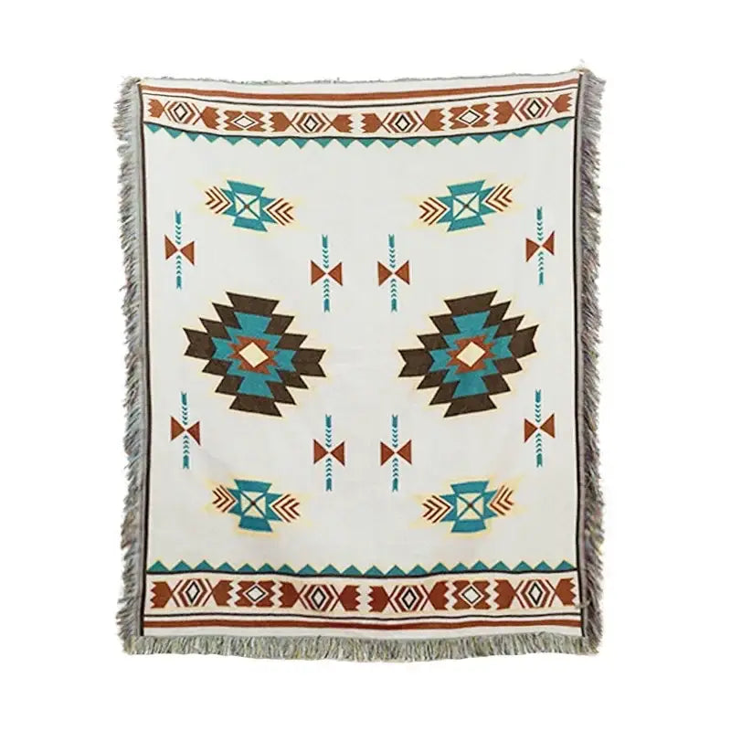 A cream-colored woven bohemian classic design thread throw blanket with teal brown black geometric patterns and fringed edges