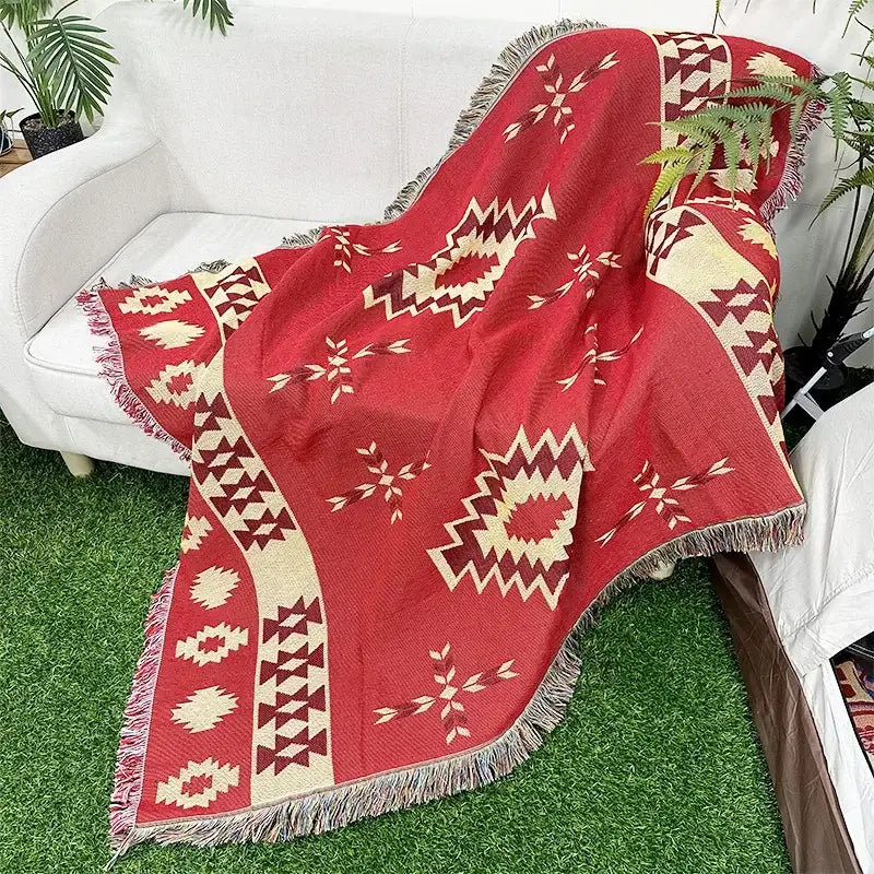 Red woven throw blanket with cream and maroon geometric patterns and fringed edges bohemian classic design thread