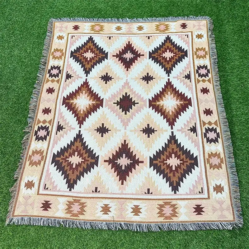 Rectangular woven throw blanket with beige brown cream geometric pattern and fringed edges from decorbites bohemian classic design thread collection
