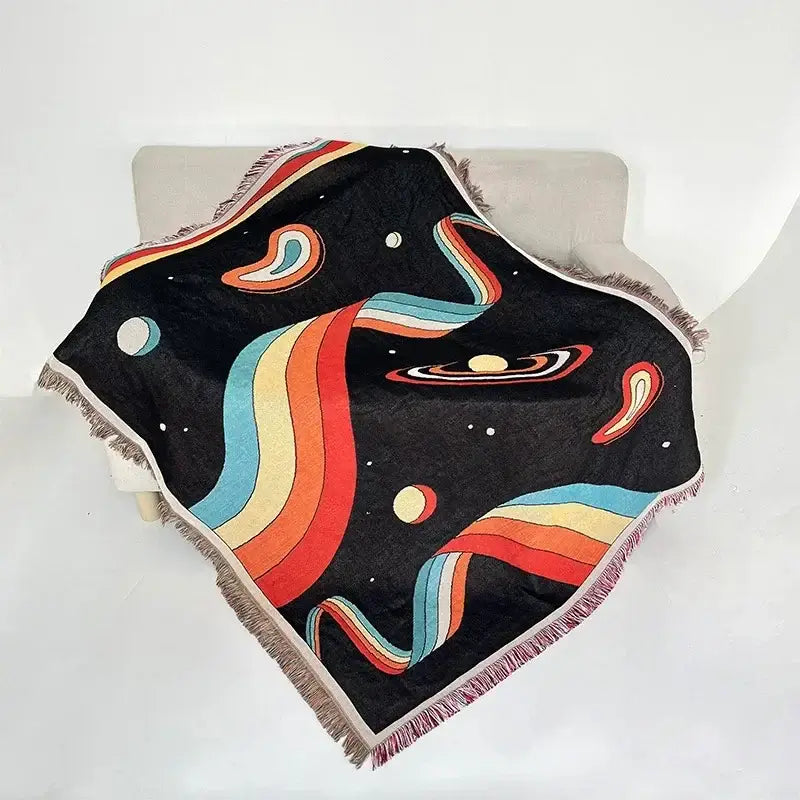 Black throw blanket with vibrant cosmic rainbow nebulae and fringed edges in decorbites bohemian classic design thread style