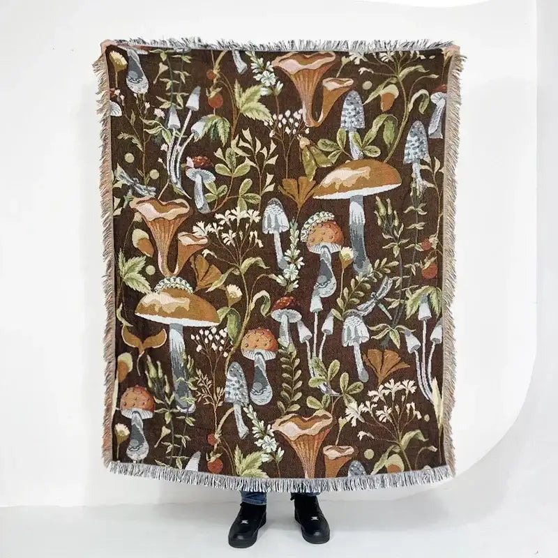 Brown woven blanket with mushroom and foliage pattern in earthy tones fringed edges bohemian classic design thread decorbites