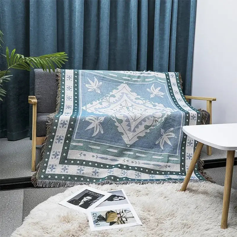 A decorbites bohemian classic soft throw blanket in blue and green with woven leaf motifs and fringe border