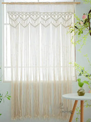 Cream-colored decorbites bohemian cotton macrame wall hanging with intricate woven patterns and long flowing fringe