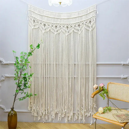 Cream-colored bohemian cotton macrame wall hanging with intricate woven patterns and long fringe decorbites bohemian cotton