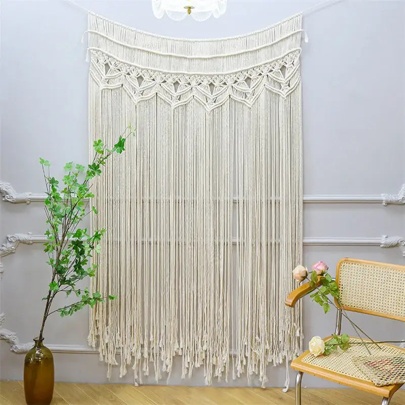 Cream-colored bohemian cotton macrame wall hanging with intricate woven patterns and long fringe decorbites bohemian cotton