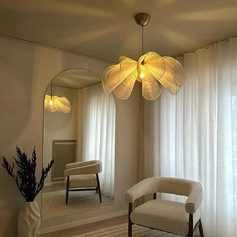 Bohemian cream fabric flower chandelier with woven petal design hangs as dining room lighting pendant light
